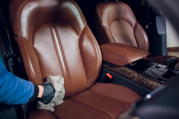 Auto service staff cleaning car interior _ Premium Photo